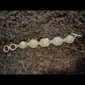 Bracelet reminds me of Konstantino. Intricate design.